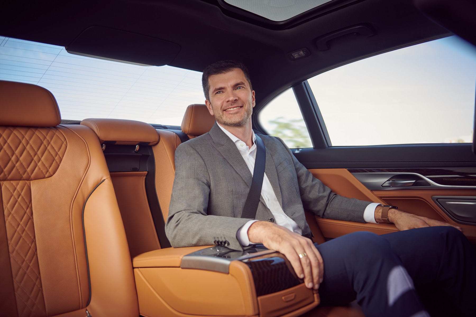 Executive passenger seated in luxury chauffeur car