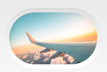 View of an airplane wing from the window seat at sunset